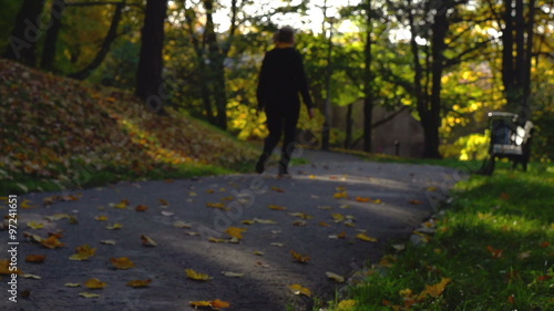 Wallpaper Mural Woman walking on path in the autumnal park, slow motion shot
 Torontodigital.ca