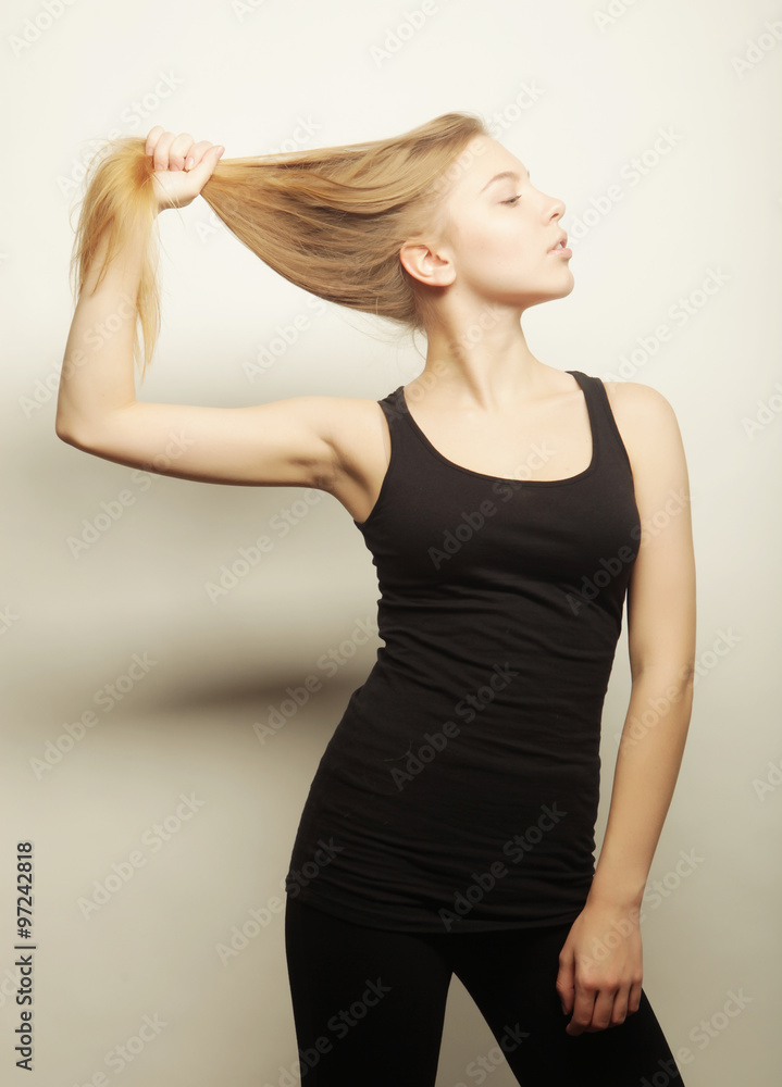 Beautiful woman with long blond hair. Fashion model posing at st Beautiful woman with long blond hair. Fashion model posing at st