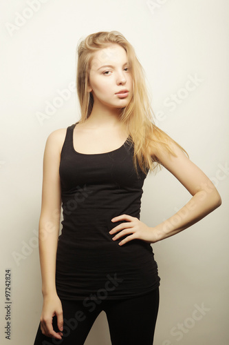 Beautiful woman with long blond hair. Fashion model posing at st