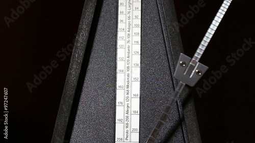 Closeup Of Metronome Arm Moving Andante Tempo
 photo