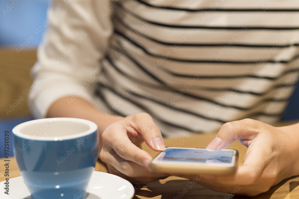 Women are using a smart phone in a cafe Women are using a smart phone in a cafe