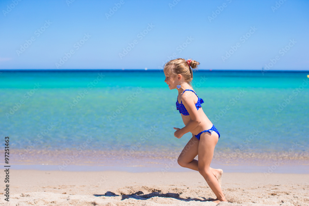 Adorable little girl at beach during summer vacation Adorable little girl at beach during summer vacation