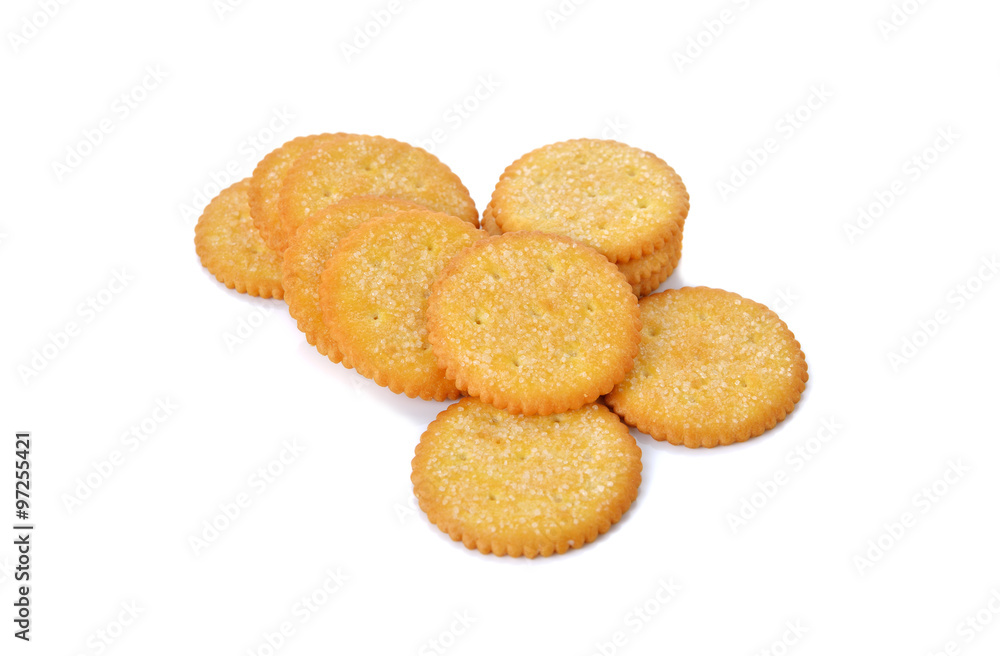 stack of round crackers with sugar on white background