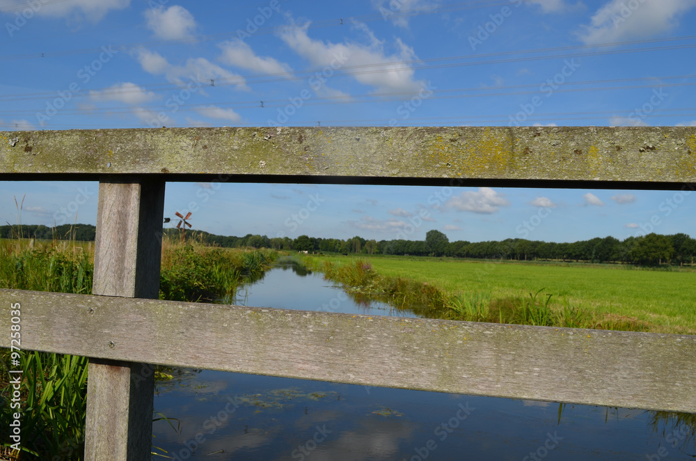 Ditch and green meadow in Dutch polder in summer, Breda Ditch and green meadow in Dutch polder in summer, Breda