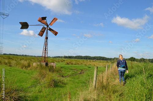 Photography Windmill in a meadow in a wet polder