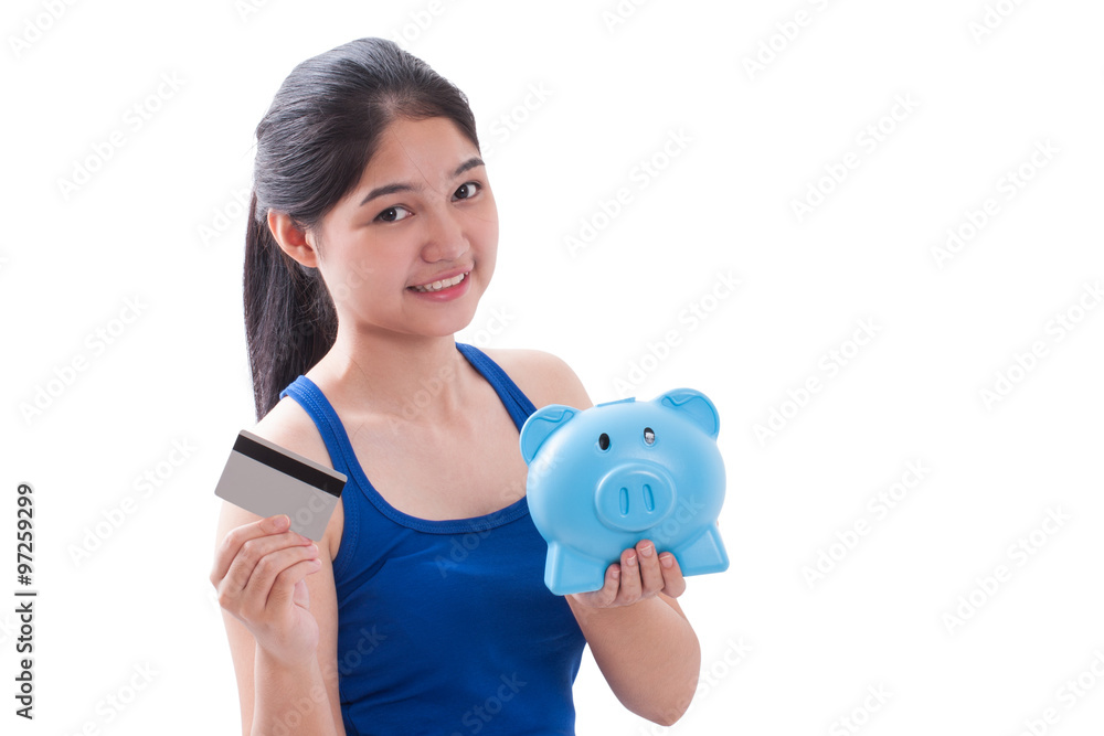 Young woman holding piggy bank and card Young woman holding piggy bank and card