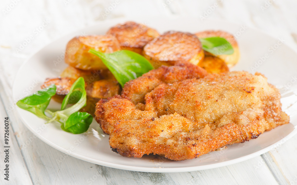 Homemade Breaded Schnitzel with Potatoes and Salad. Homemade Breaded Schnitzel with Potatoes and Salad.