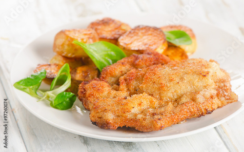 Homemade Breaded Schnitzel with Potatoes and Salad.
