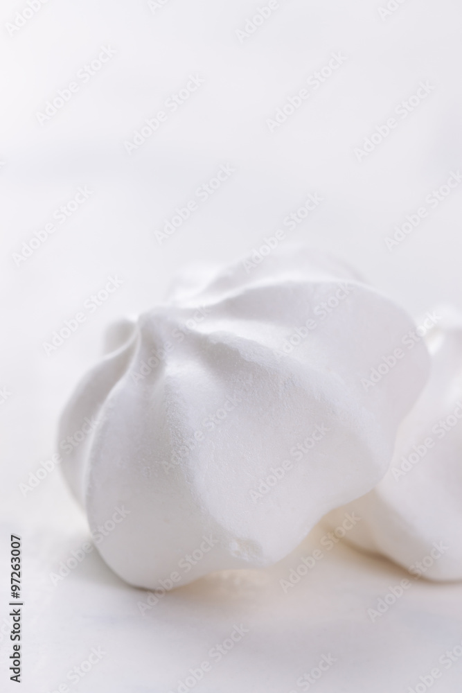Closeup of meringue cookies on a white background, selective focus. Closeup of meringue cookies on a white background, selective focus.