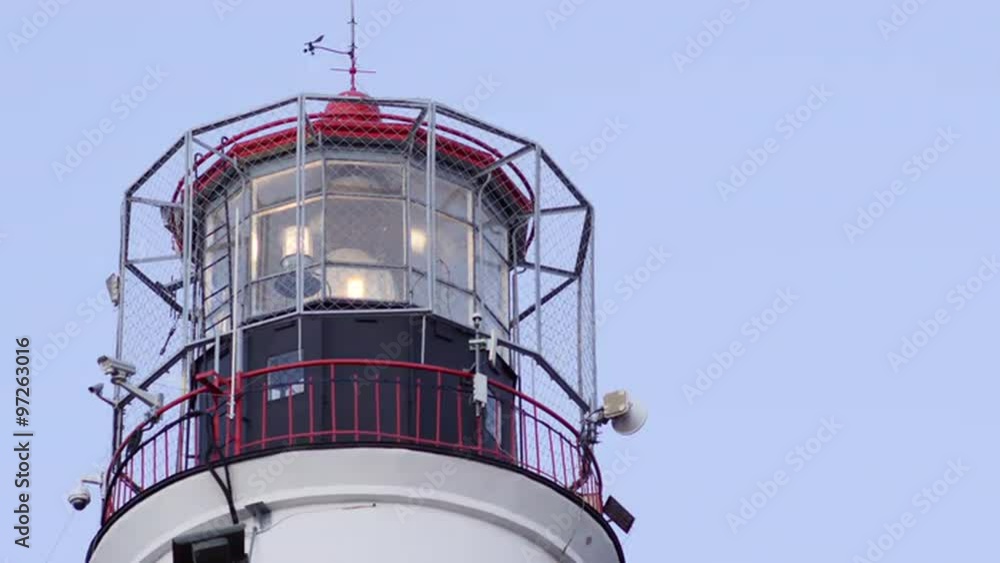 Close up of a working lighthouse tower with a rotating light beam Close up of a working lighthouse tower with a rotating light beam