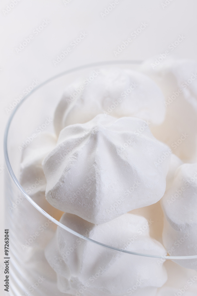 Closeup of meringue cookies in a glass on a white background Closeup of meringue cookies in a glass on a white background