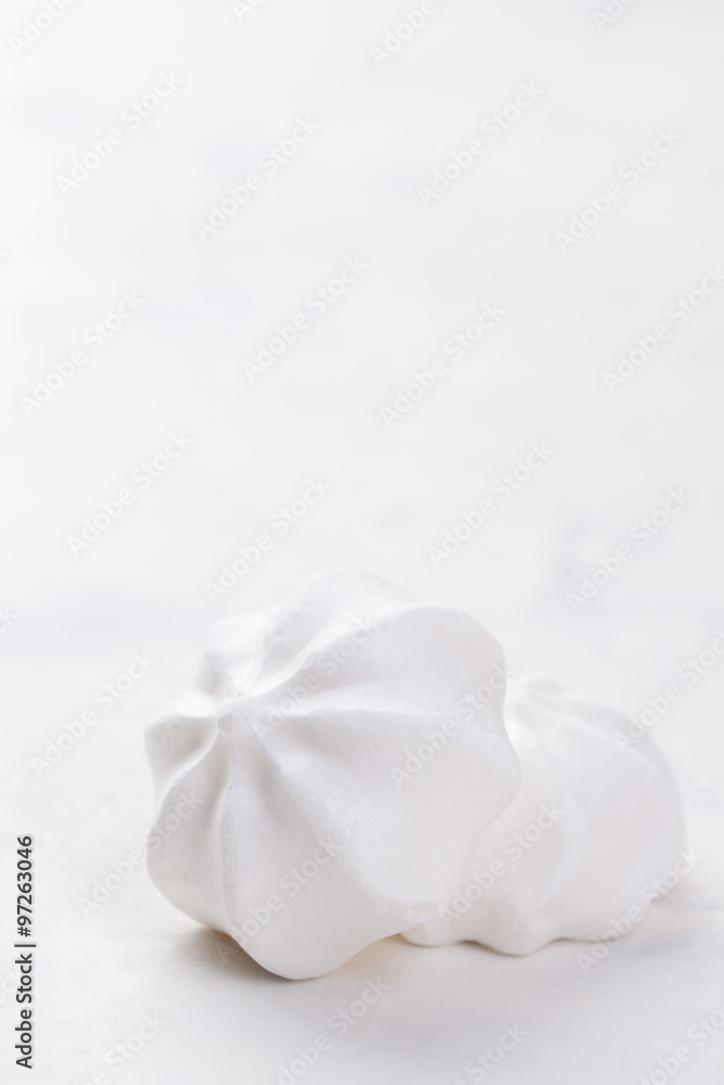 Closeup of meringue cookies on a white background, selective focus.