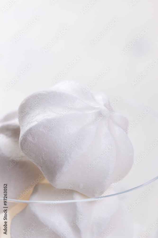 Closeup of meringue cookies on a white background, selective focus
