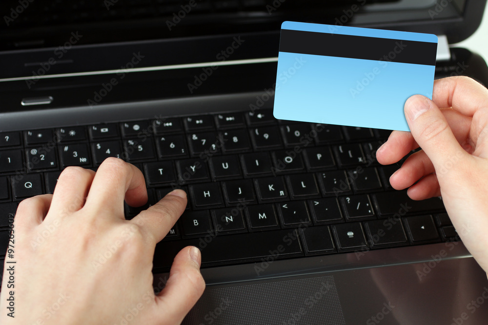 credit card in hand the woman and the opened laptop on white isolated background credit card in hand the woman and the opened laptop on white isolated background