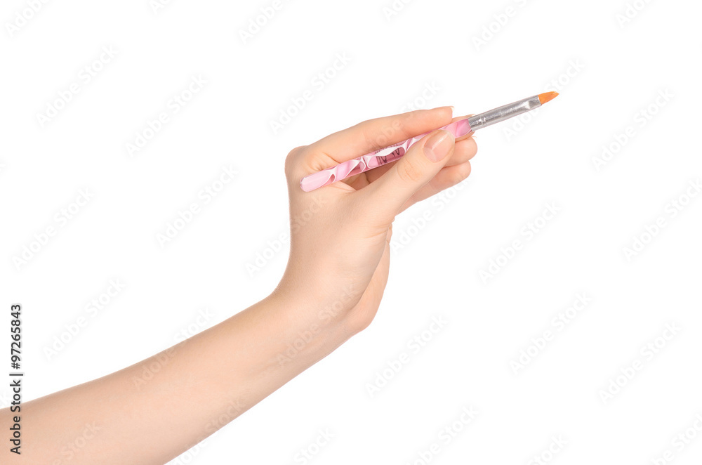 Beauty and makeup topic: a woman's hand holding a brush makeup isolated on white background in studio Beauty and makeup topic: a woman's hand holding a brush makeup isolated on white background in studio