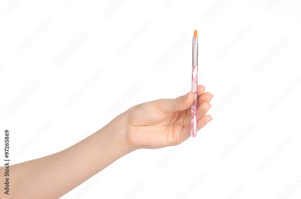 Beauty and makeup topic: a woman's hand holding a brush makeup isolated on white background in studio Beauty and makeup topic: a woman's hand holding a brush makeup isolated on white background in studio