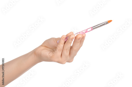 Beauty and makeup topic: a woman's hand holding a brush makeup isolated on white background in studio