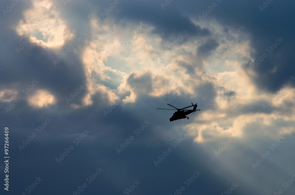 silhouette of a helicopter in the sun