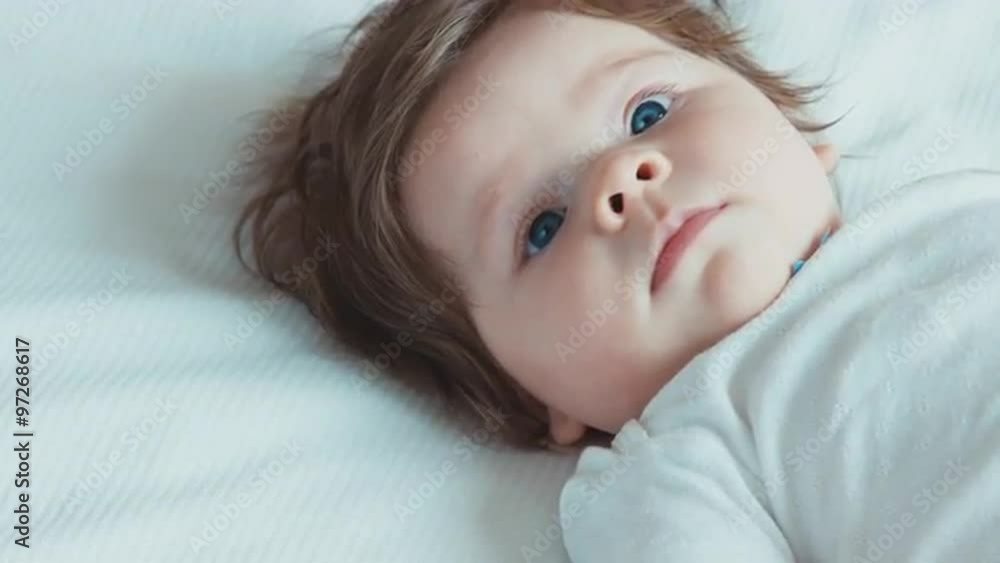 Blue eyed newborn baby looking at the camera Blue eyed newborn baby looking at the camera