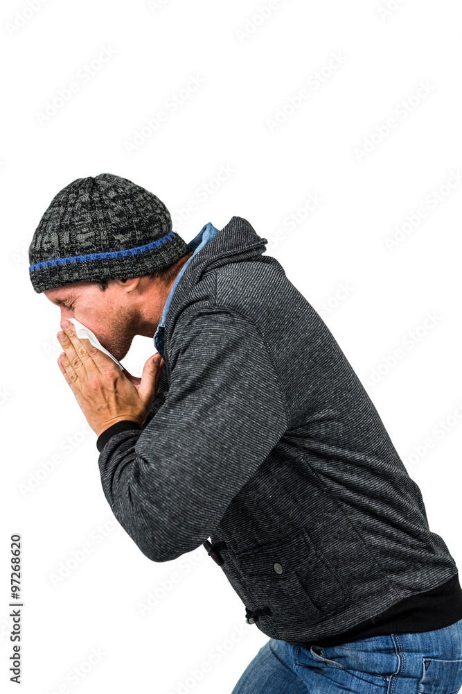 Warmly dressed man blowing his nose Warmly dressed man blowing his nose