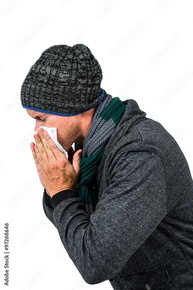 Warmly dressed man blowing his nose Warmly dressed man blowing his nose