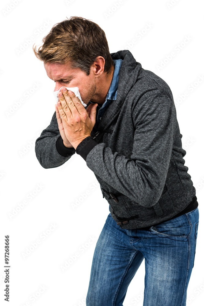 Warmly dressed man blowing his nose Warmly dressed man blowing his nose