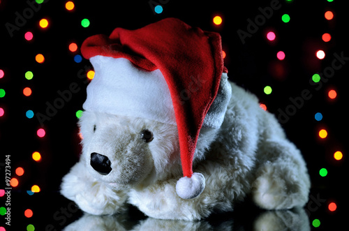 New Year white teddy bear in a Christmas hat. Christmas dec