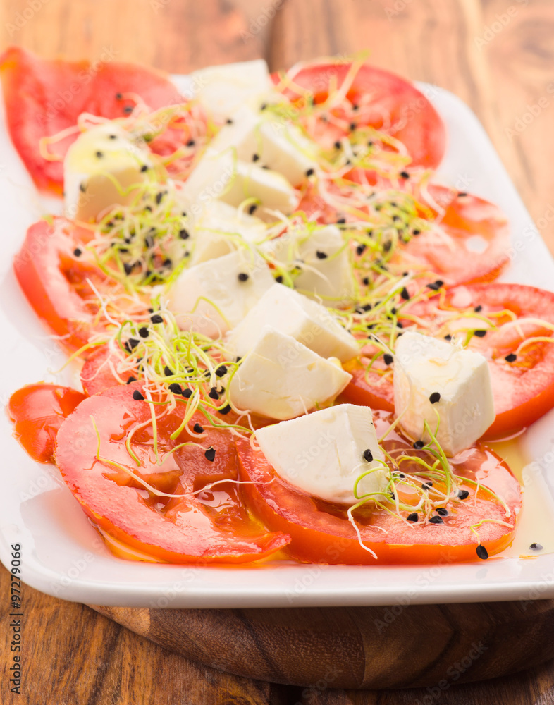 tray tomato salad with goat cheese and onion sprouts tray tomato salad with goat cheese and onion sprouts