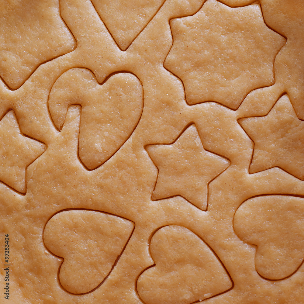 Dough rolled out and cookies cut out Dough rolled out and cookies cut out