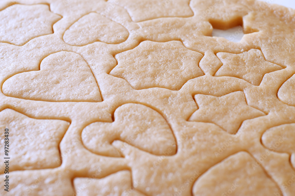Dough rolled out and cookies cut out Dough rolled out and cookies cut out