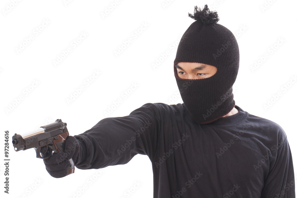 Burglar in a mask with a gun on a white background Burglar in a mask with a gun on a white background