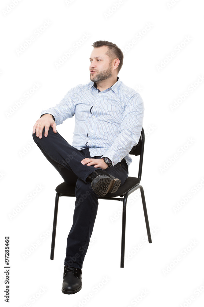 man sitting on chair. Isolated white background. Body language. gesture.  Training managers. sales agents. legs crossed, fixed arm. misses. dominant  position Stock Photo | Adobe Stock