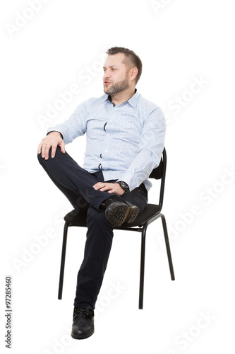 man sitting on chair. Isolated white background. Body language. gesture.  Training managers. sales agents. legs crossed, fixed arm. misses. dominant  position Stock Photo | Adobe Stock