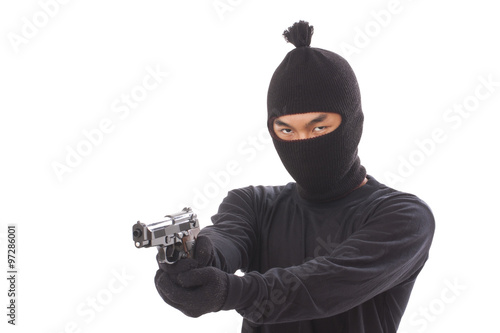 Burglar in a mask with a gun on a white background