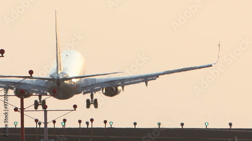 HD clip of a narrow body twin engine jet coming in for a landing during sunset