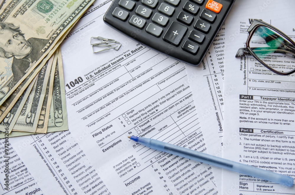 tax forms 1040 with the glasses, money and the pen tax forms 1040 with the glasses, money and the pen