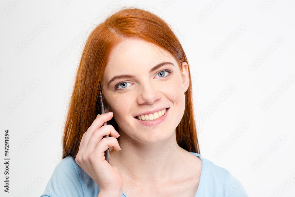 Smiling redhead woman talking on the phone Smiling redhead woman talking on the phone
