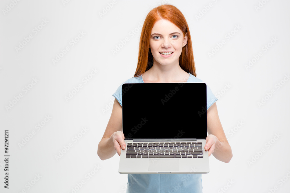 Redhead woman showing blank laptop computer screen Redhead woman showing blank laptop computer screen