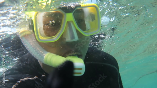 PORT DOUGLAS, AUSTRALIA - MARCH 2: American tourst, Jose Gil, snorkles with Quicksilver cruises on March 2, 2014 in the Great Barrier Reef near Port Douglas, Australia. photo