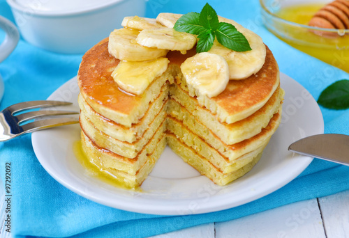 Pancake with banana, covered with honey or maple syrup 