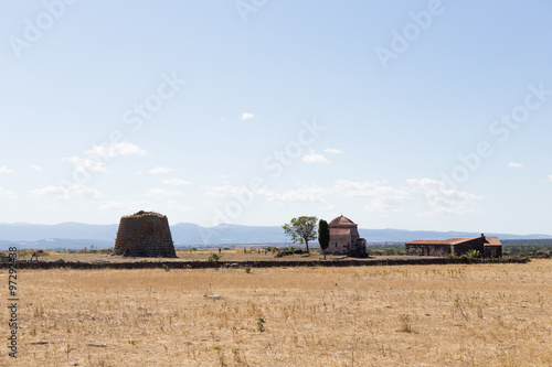 empty and desolated landscape with nuraghe in background