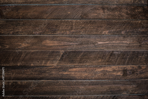Old dark wooden rustic plank fence background.