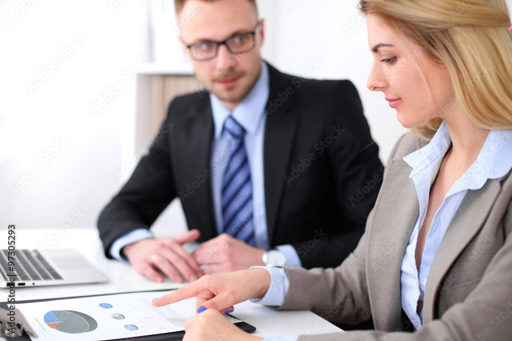 Two successful business partners working at meeting in office Two successful business partners working at meeting in office