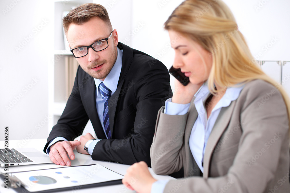 Two successful business partners working at meeting in office Two successful business partners working at meeting in office