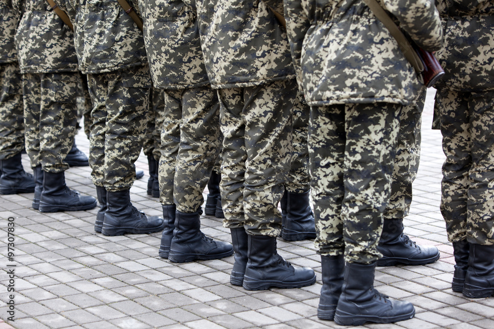 Armed Soldiers in Camouflage Uniforms Armed Soldiers in Camouflage Uniforms