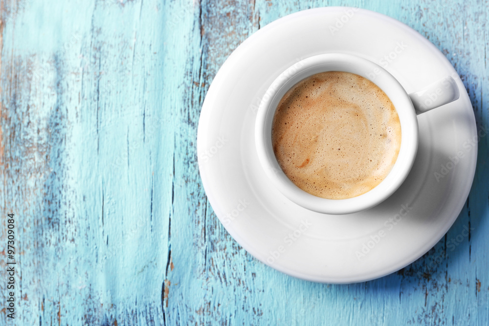Cup of coffee on color wooden background Cup of coffee on color wooden background
