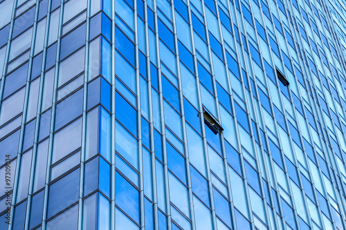 there must be an exception, asymmetrical image of glassy modern building, with two windows open on northern side of the skyscraper