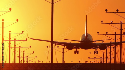 HD clip of a narrow body twin engine jet coming in for a landing during sunset