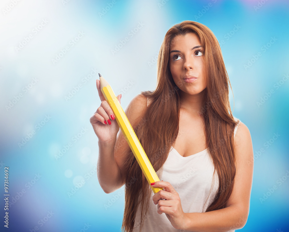 portrait of a young woman holding a yellow pencil portrait of a young woman holding a yellow pencil