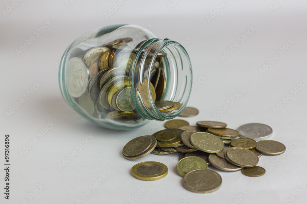 business, finance, investment, money saving - coins in glass jar on table business, finance, investment, money saving - coins in glass jar on table